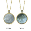 Two Virgo zodiac pendant necklaces with carved black and white mother-of-pearl inlay on white background by Celestial Creations.