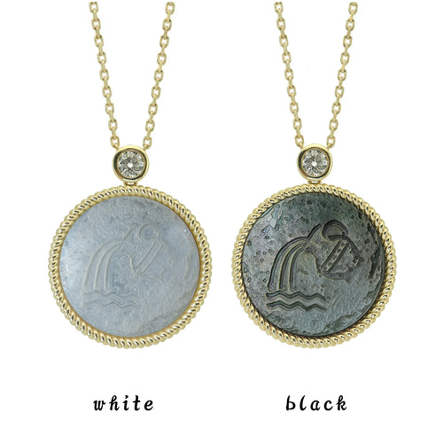 Two Aquarius zodiac pendant necklaces with carved black and white mother-of-pearl inlay on white background by Celestial Creations.