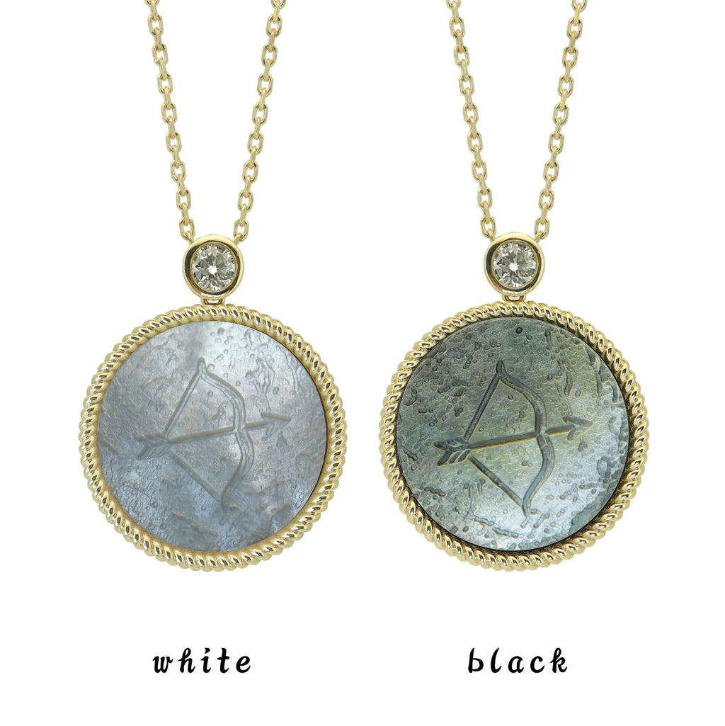 Two Sagittarius zodiac pendant necklaces with carved black and white mother-of-pearl inlay on white background by Celestial Creations.