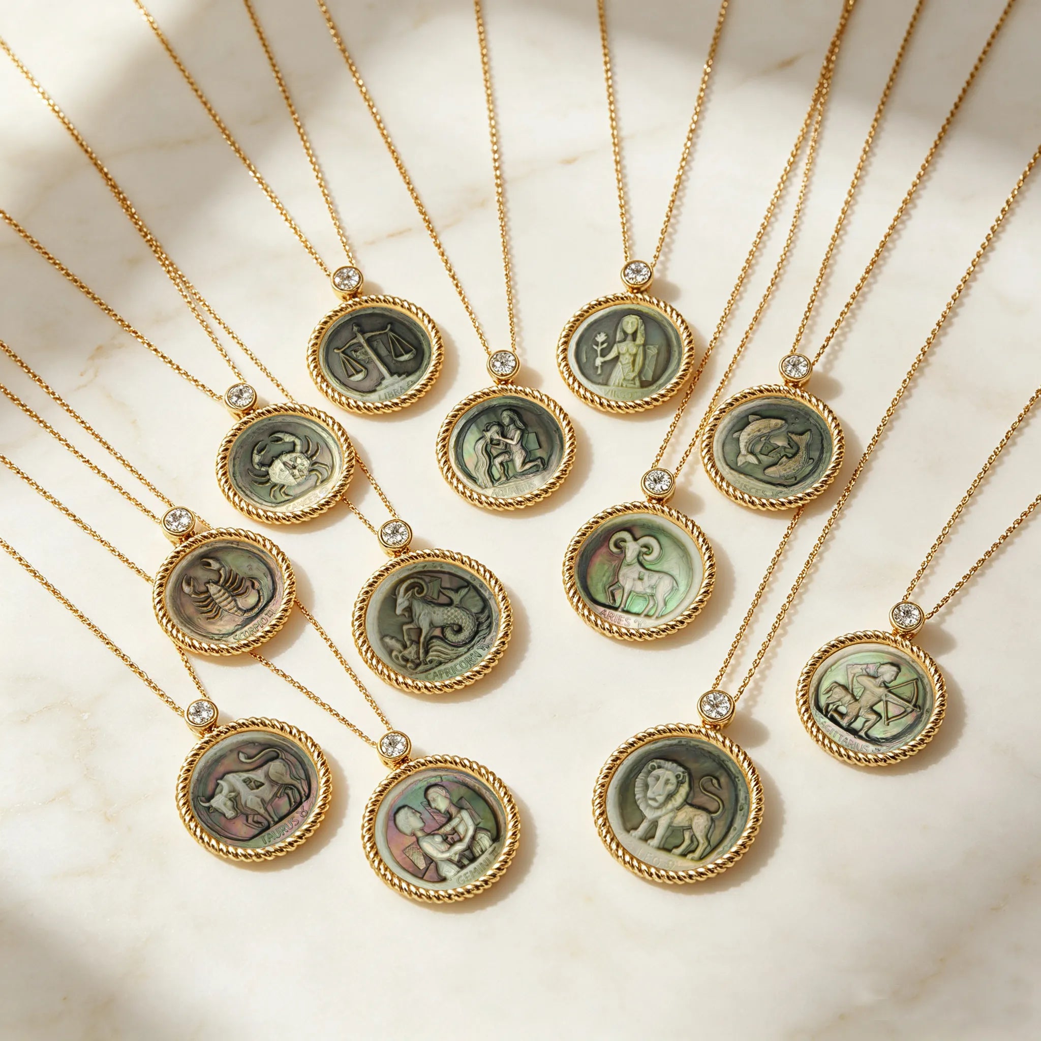 Picasso-inspired abstract zodiac necklace collection featuring 12 constellation designs carved in natural iridescent mother-of-pearl relief by OceanCarvingLab.