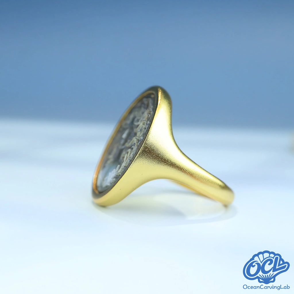 Cancer crab figure engraved on white iridescent nacre for a soft lunar aesthetic.