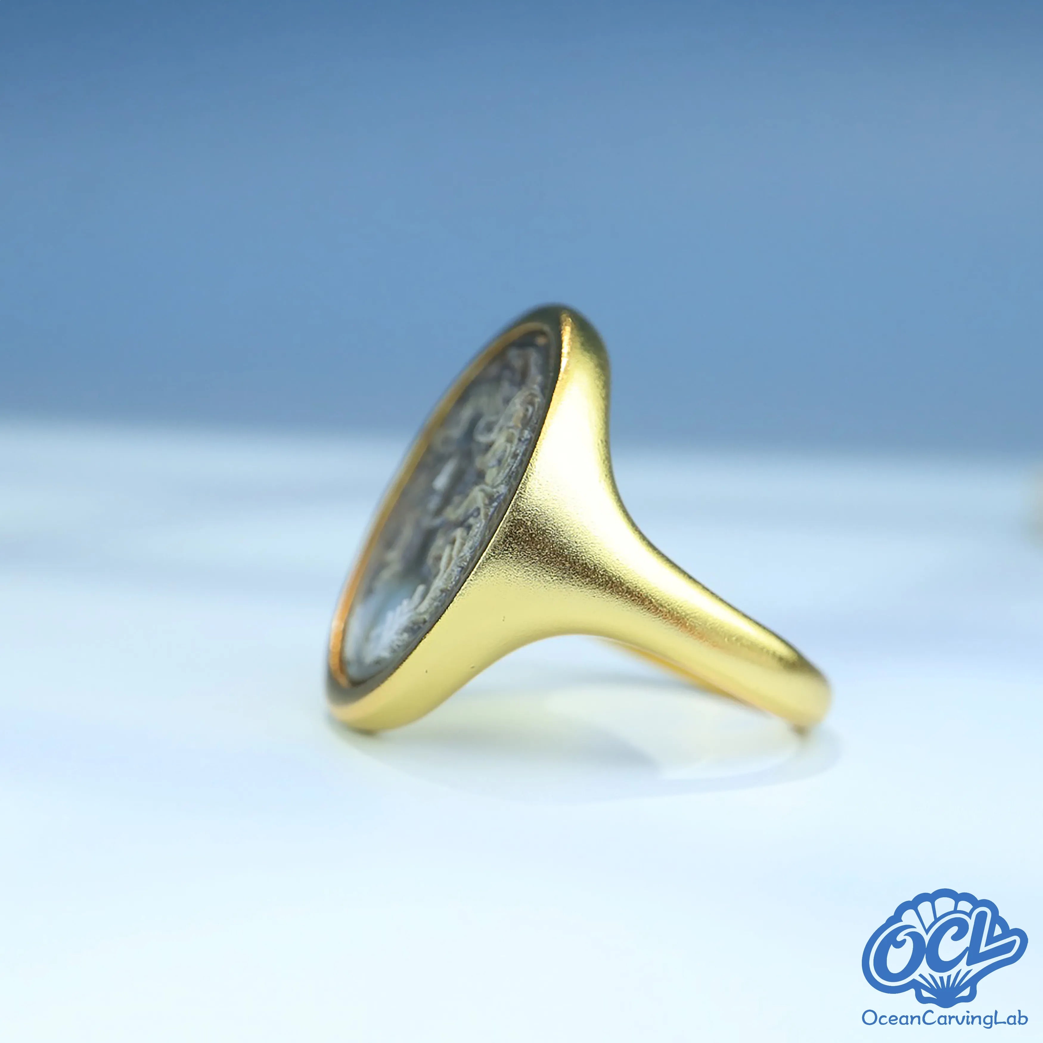 Cancer crab figure engraved on white iridescent nacre for a soft lunar aesthetic.