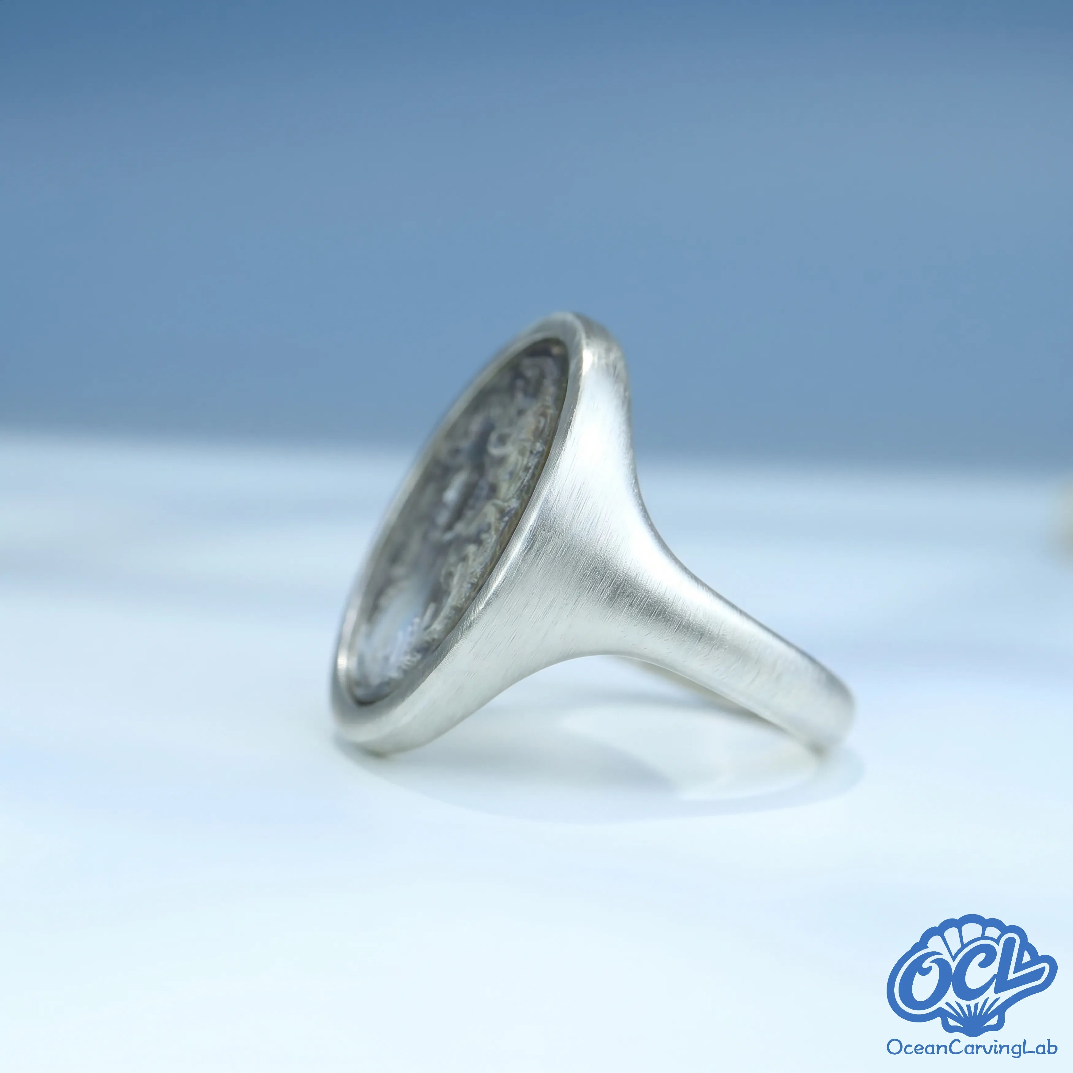 Hand-polished silver ring featuring natural white mother of pearl with a high-luster finish.