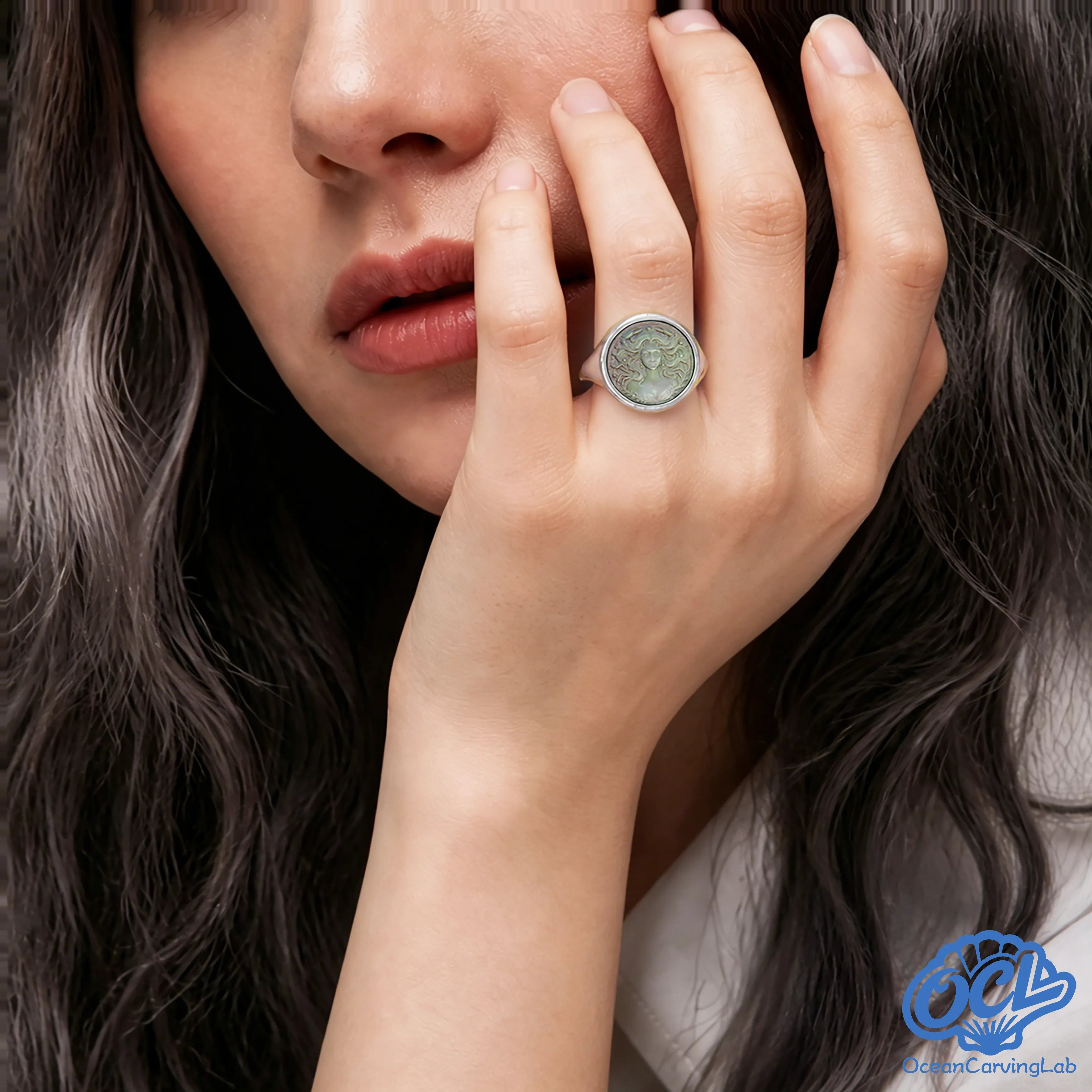 Sentimental Cancer zodiac ring worn on a hand, reflecting a cool silver glow.