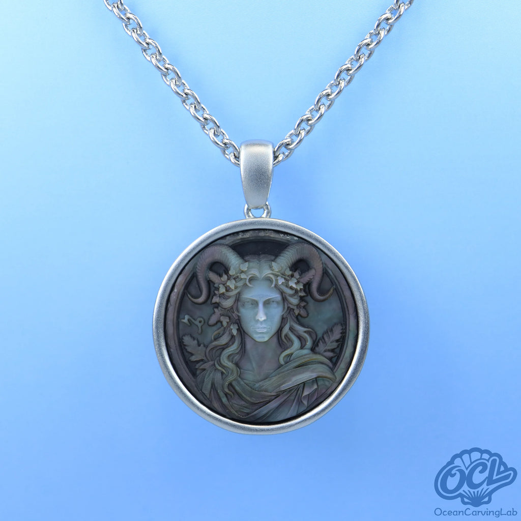 Detailed Capricorn sea-goat figure on white iridescent mother of pearl, reflecting bright light.