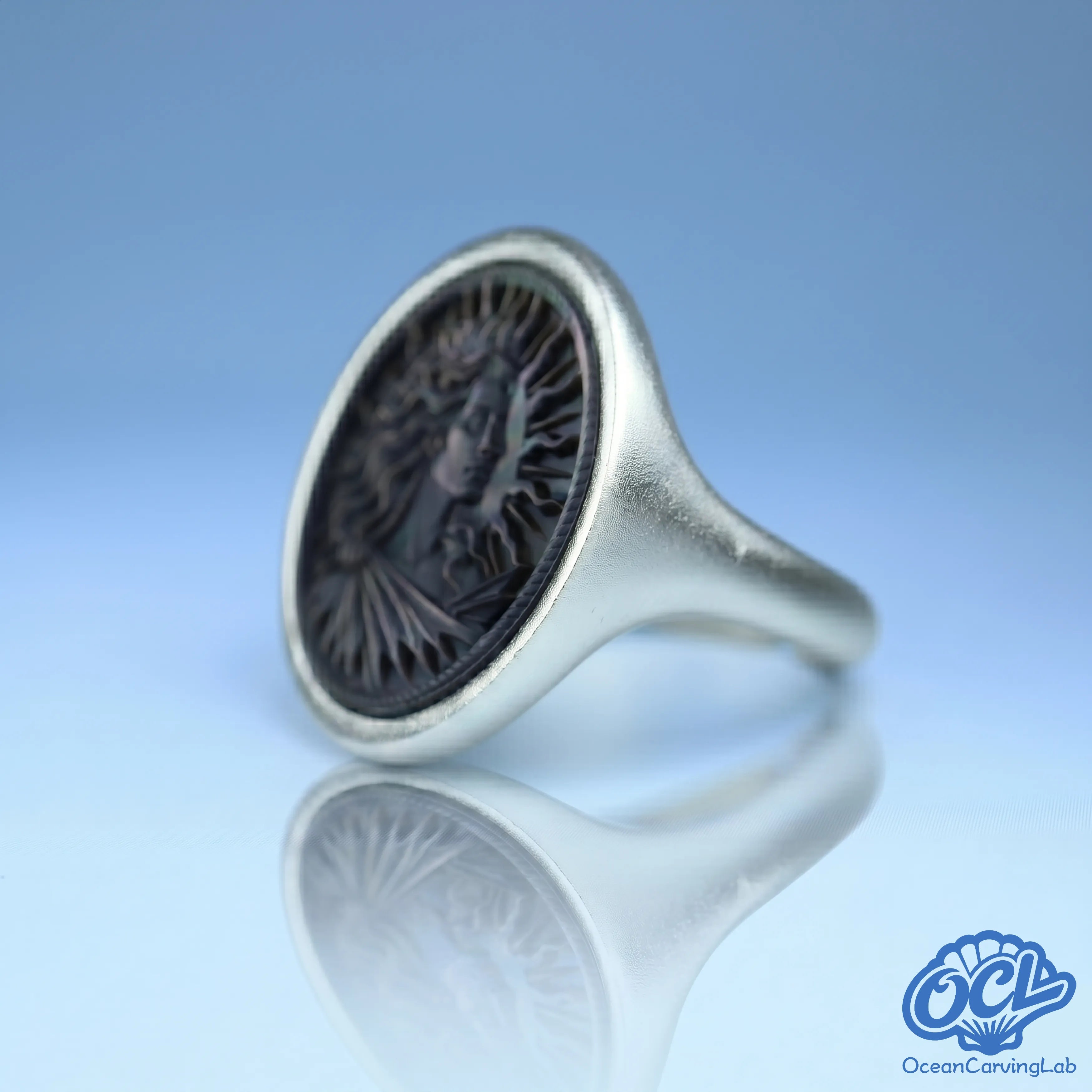 Regal Leo statement ring with high-polish 24k gold finish and manual shell setting.