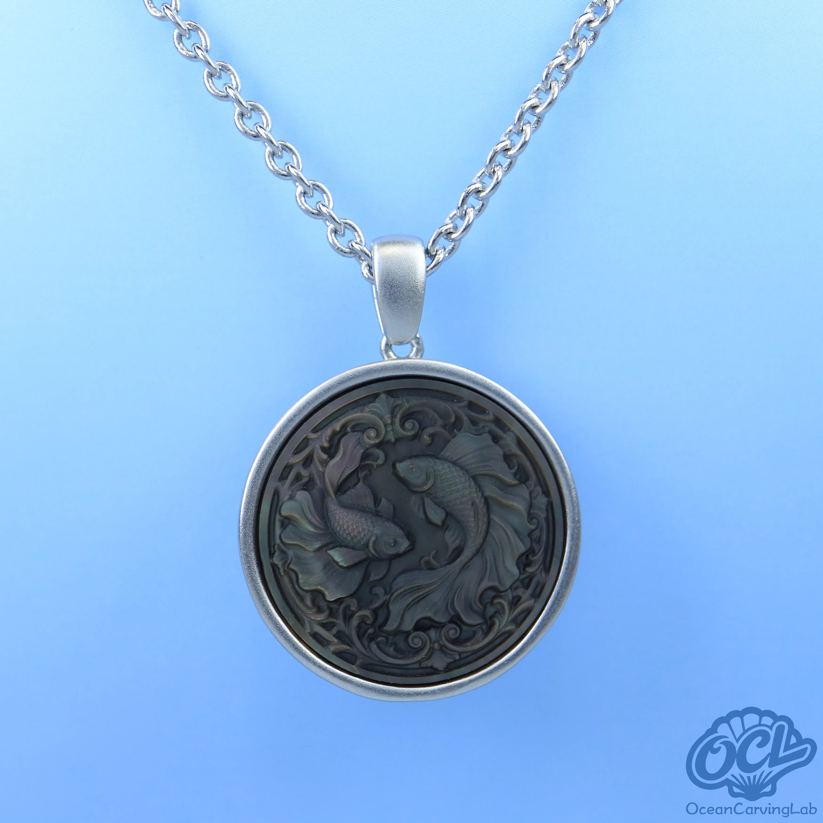 Detailed Pisces constellation engraved on white iridescent mother of pearl for a lunar glow.
