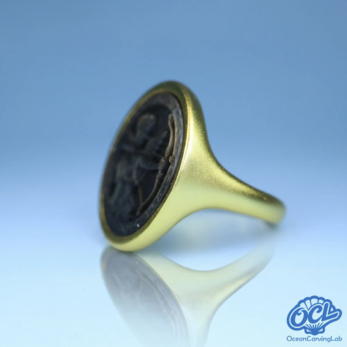 Dynamic archer symbol engraved on white iridescent shell using high-precision CNC technology.