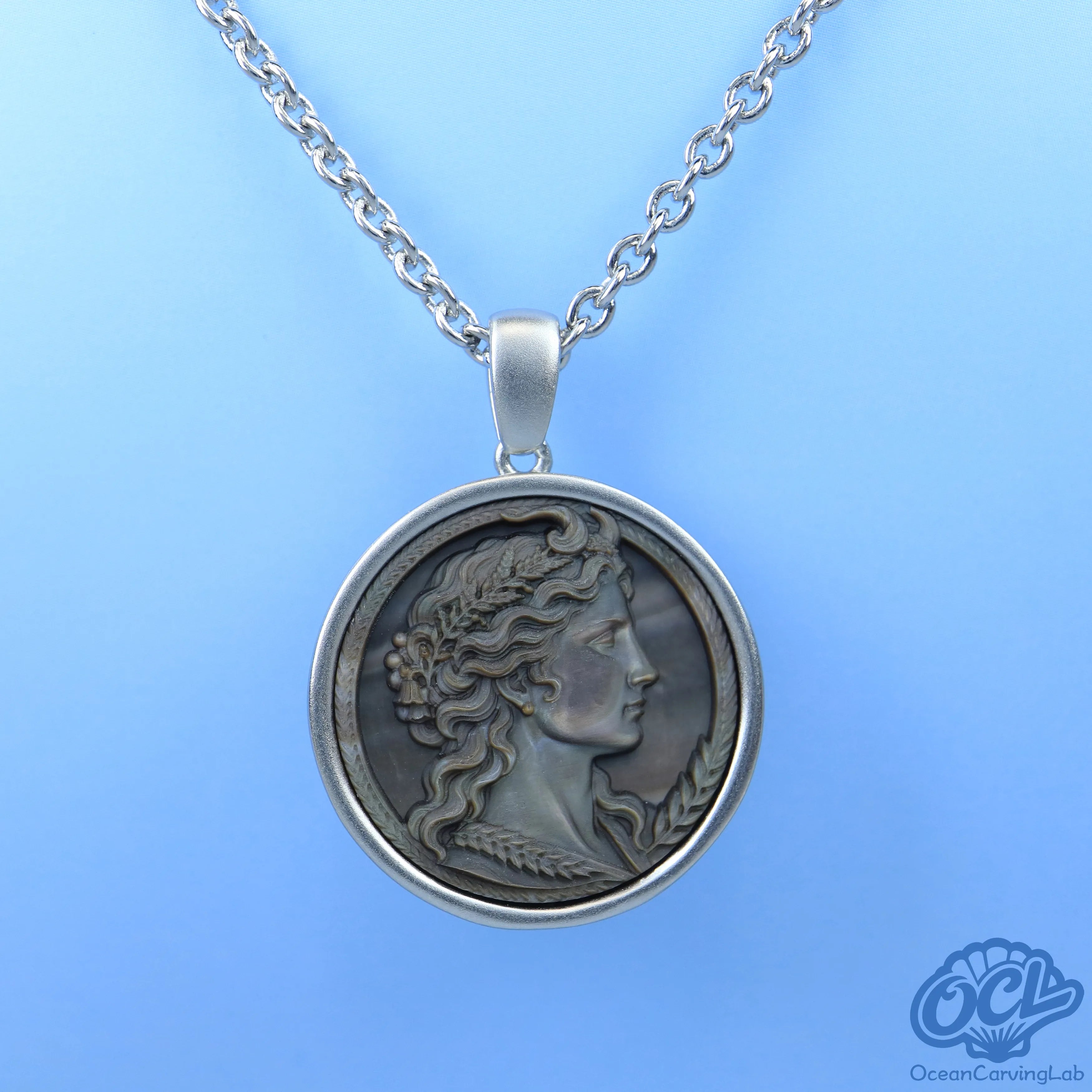 Minimalist Taurus bull engraving on iridescent white shell, showcasing natural nacre glow.