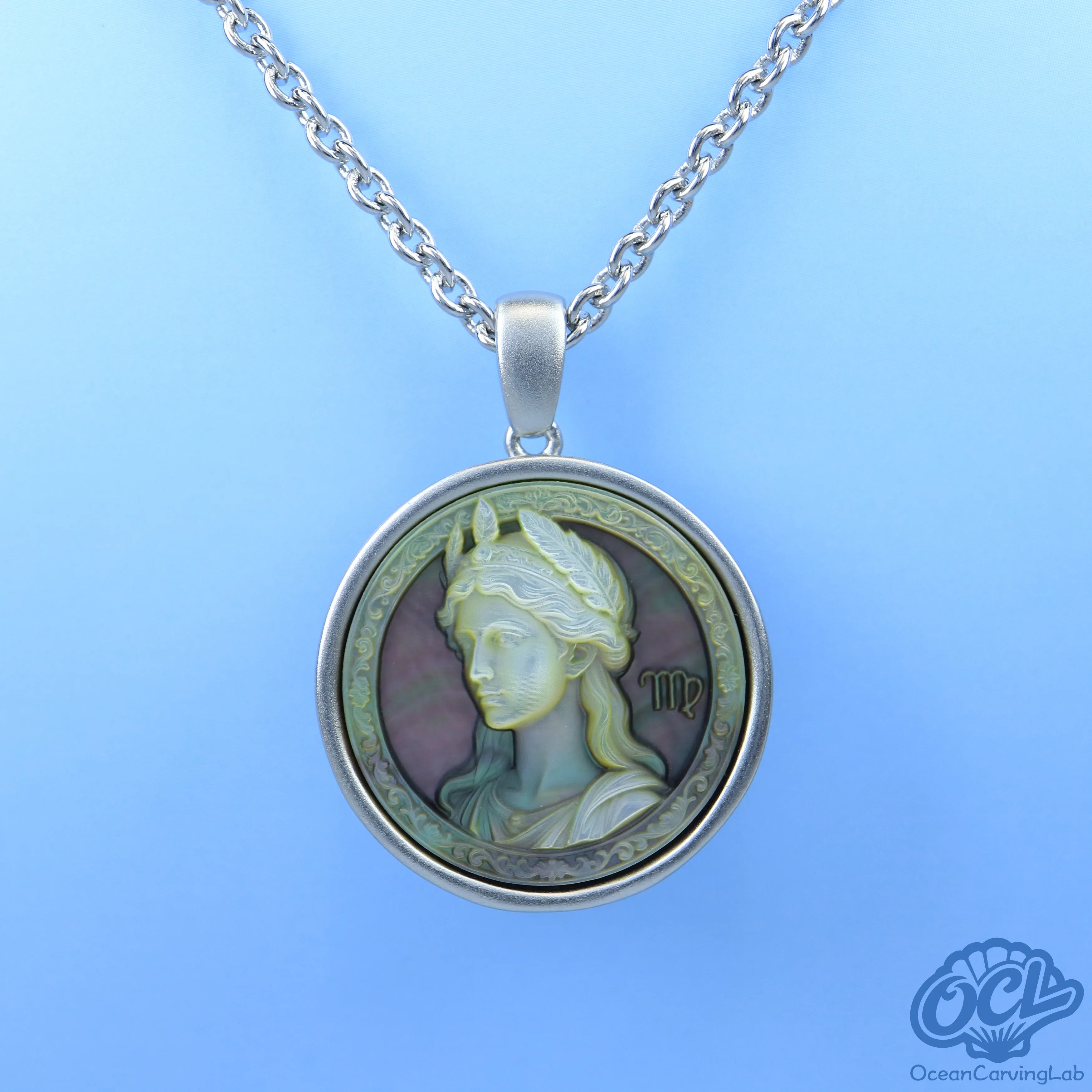 Detailed Virgo maiden engraving on iridescent black shell disc using high-precision CNC.
